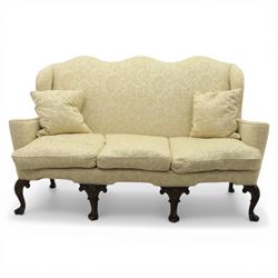 19th century Queen Anne style cream foliate upholstered three seat settee, the shaped and waisted back with serpentine cresting, padded arms over loose seat cushions, raised upon carved cabriole supports with shell carved knees