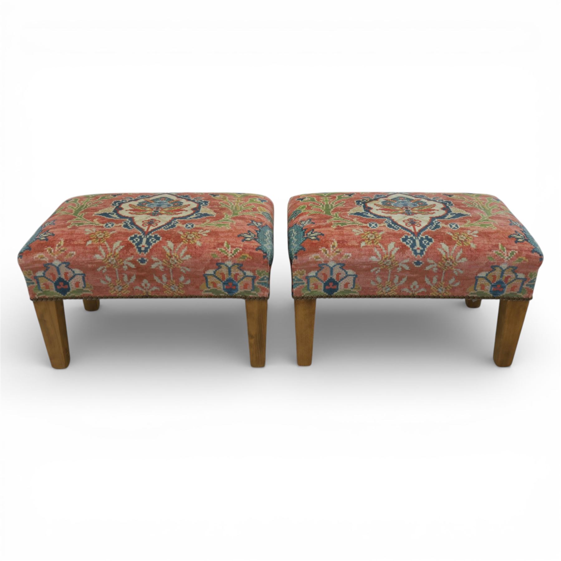 Pair of needlepoint footstools, retailed by The Bespoke Footstool Co, brass studded trim on tapered oak supports
