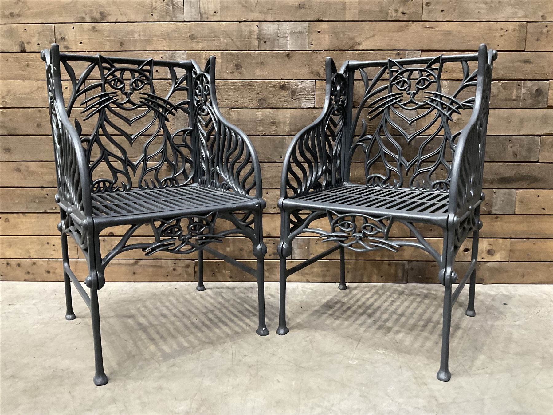 Richard Bawden (1936-2024): Pair of Cat design painted cast iron garden armchairs