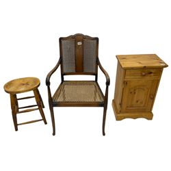 Waxed pine single pedestal dressing table, pine bedside cabinet, bergere chair and a stool