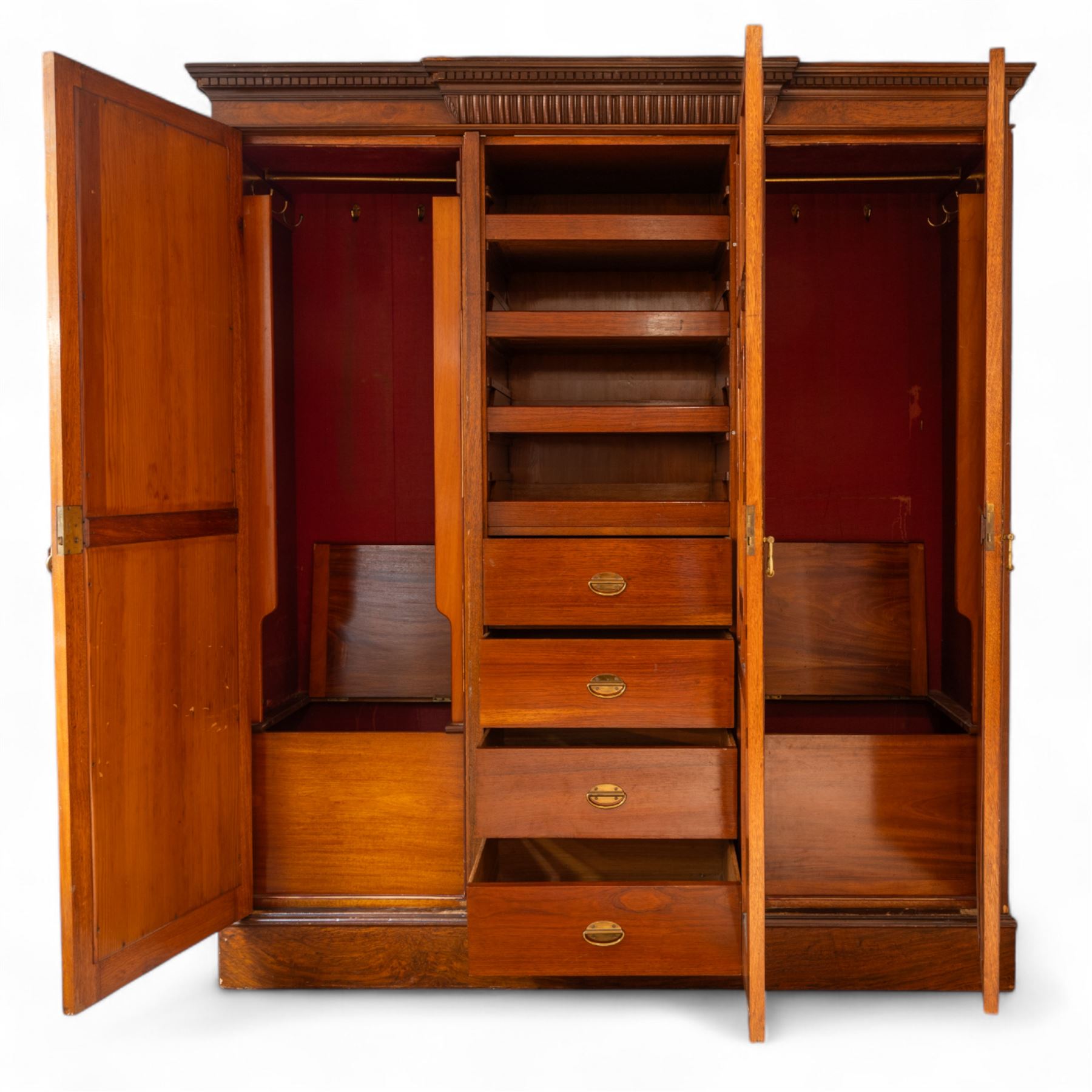 Late Victorian oak and burr oak three-section mirror wardrobe, central door with three carved panels with shell and acanthus decoration, fitted with four drawers and four tray drawers, linen sides with bevelled mirrored panel doors with hanging space, plinth base, and dental cornice
