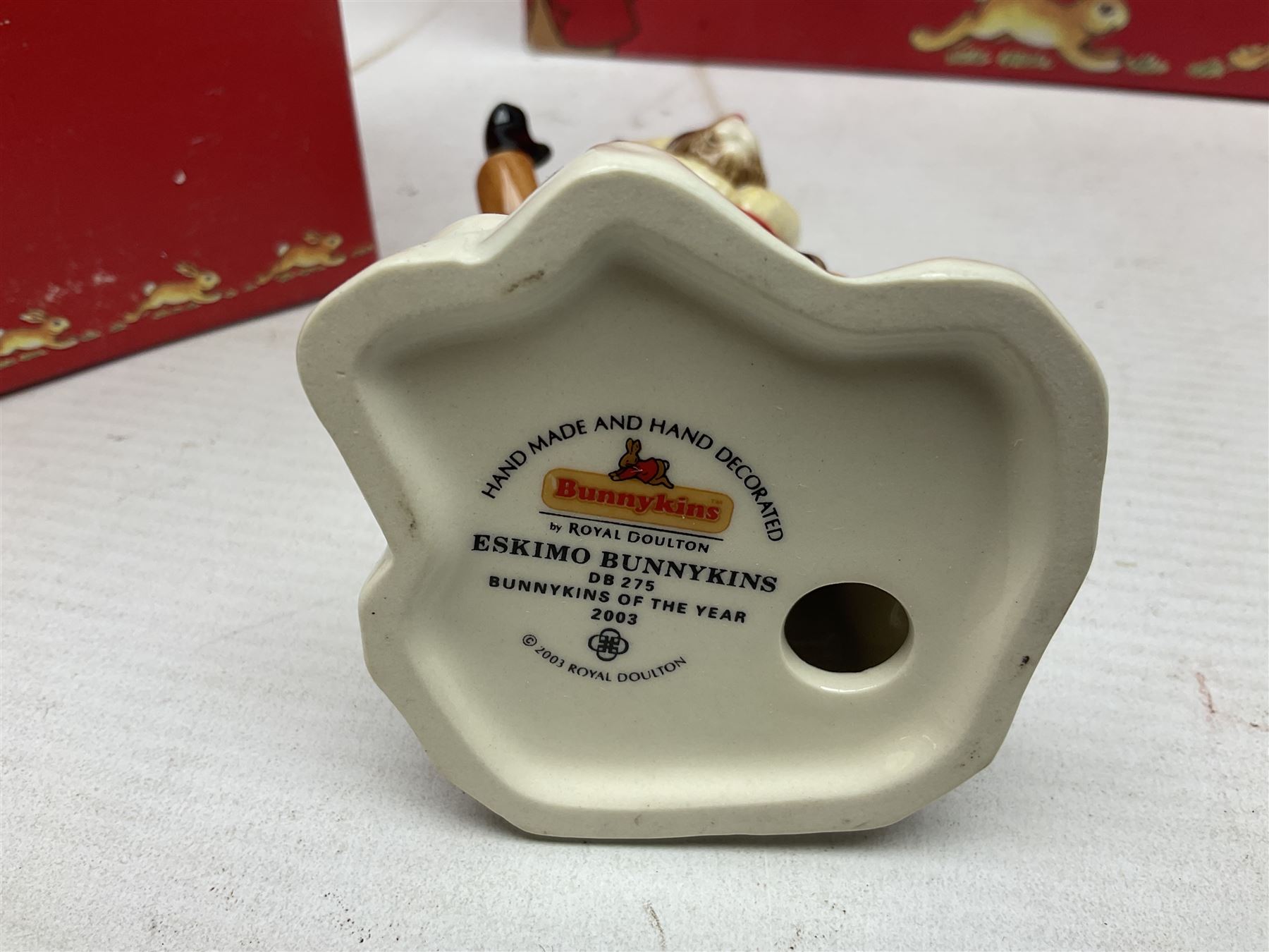 Royal Doulton The Mickey Mouse Collection Pluto figure, Coalport Characters The Snowman Dressing Up figure, three Royal Doulton Bunnykins figures comprising Policeman, Morris Danger and Eskimo, and display stand, Royal Doulton John Beswick Tiggy Winkle, Royal Albert Beatrix Potter Peter Postbag and three Goebel Hummel figures, all boxed