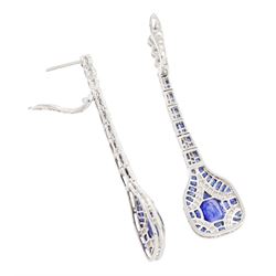 Pair of platinum sapphire and diamond pendant earrings, each stud milgrain set with a single oval cut sapphire, surrounded by calibre cut sapphires and single cut diamonds, suspending from six graduating articulated panels, to four single cut diamonds, total sapphire weight approx 3.80 carat, total diamond weight approx 0.80 carat