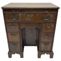 Georgian walnut kneehole desk, moulded rectangular top with book-matched veneers within crossbanding, fitted with slide over one long drawer, frieze drawer, six small drawers and recessed cupboard, raised on bracket feet