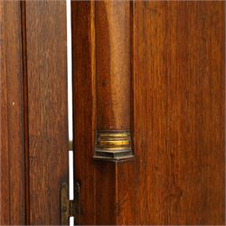 George III oak and mahogany bound enclosed bookcase-secretaire, panelled cupboards over four drawers