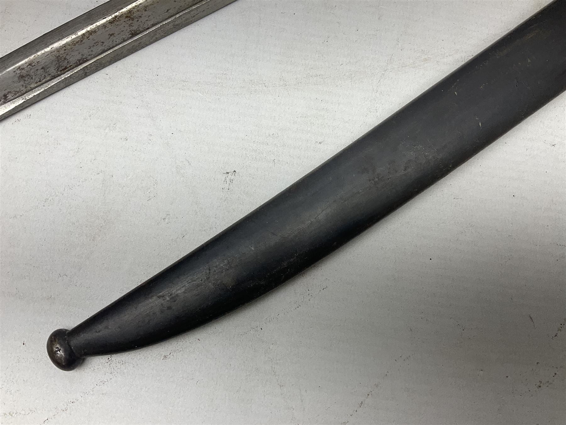 French Model 1866 Chassepot bayonet with 57cm curving fullered steel blade dated 1873 No.L63963; in steel scabbard with conforming number L71.5cm overall; and French St. Etienne Gras bayonet dated 1878 No.K10674 in steel scabbard numbered 79437 (2)