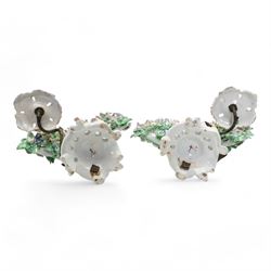 Pair of Bow porcelain 'New Dancers' candlesticks, standing before flowering bocages, and wearing brightly coloured flowered clothes, each supporting to left and right a tôle peinte branch terminating in a leaf moulded nozzle, on scrolling footed bases, red anchor and blue/red dagger marks beneath, H19cm x W18cm (2)