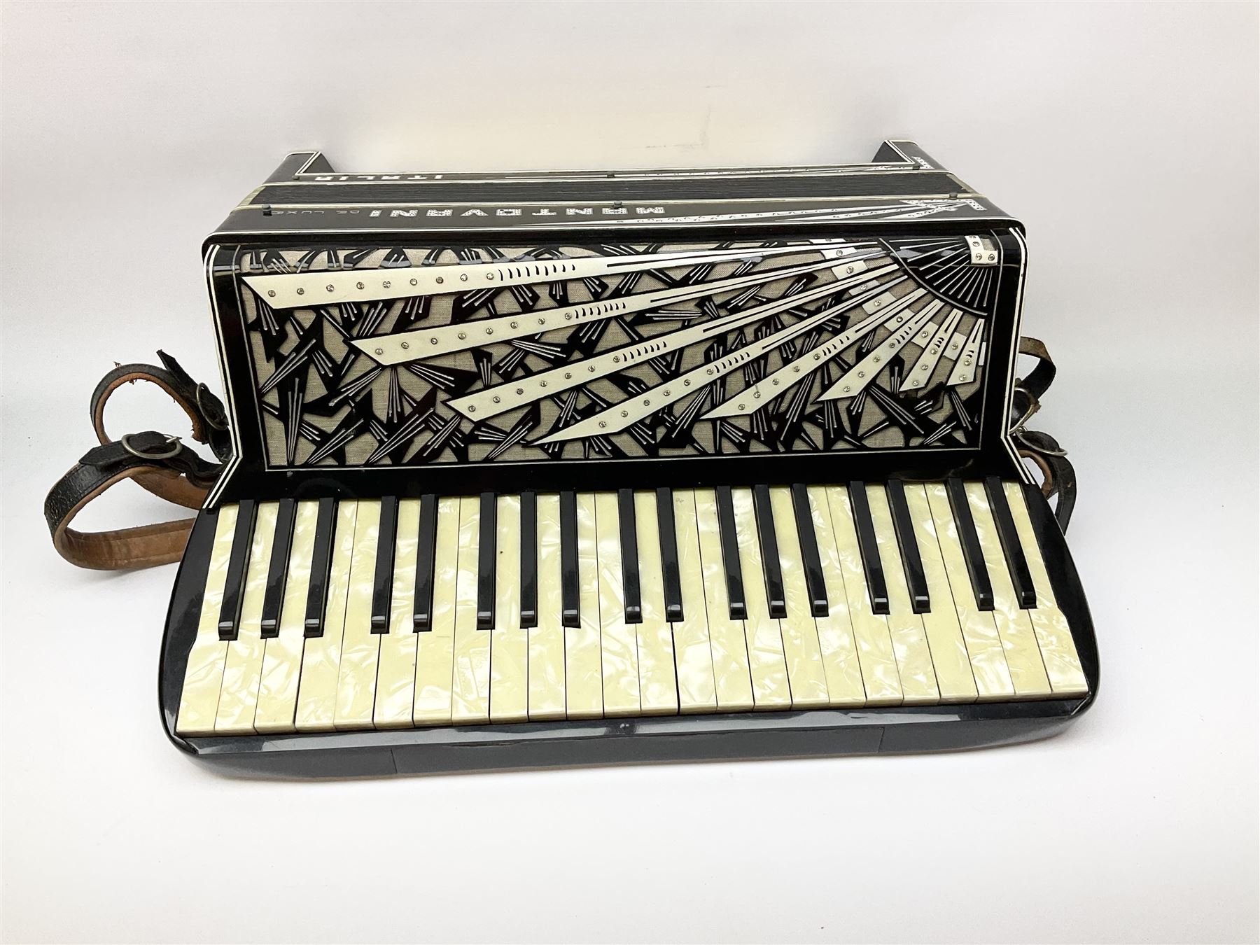 Italian Mantovani piano accordion with Art Deco style black and white case, twenty-four keys and one-hundred and twenty buttons L52cm in carrying case
