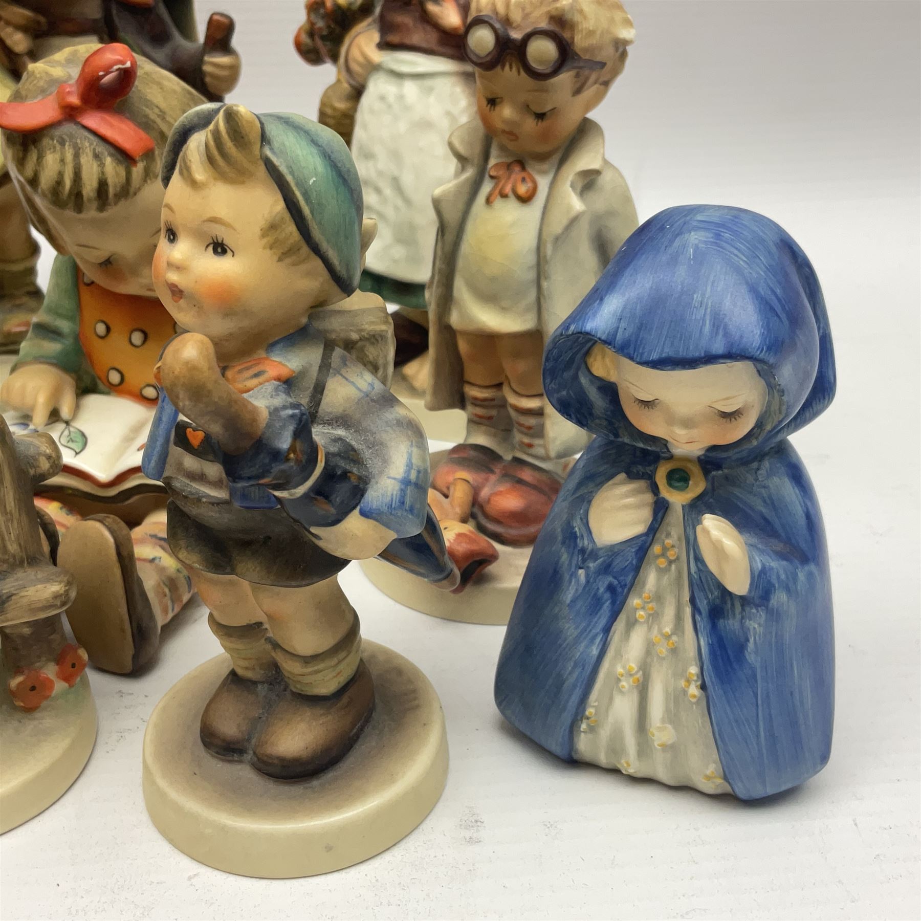 Sixteen Goebel Hummel figures, including Charlot A Young Man's Fancy, Stormy Weather and Bookworm, all with impressed and printed marks beneath
