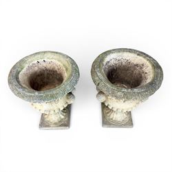Pair of large cast stone garden urns, circular form with egg and dart border, tapering gadrooned bowl with cast handles and detail