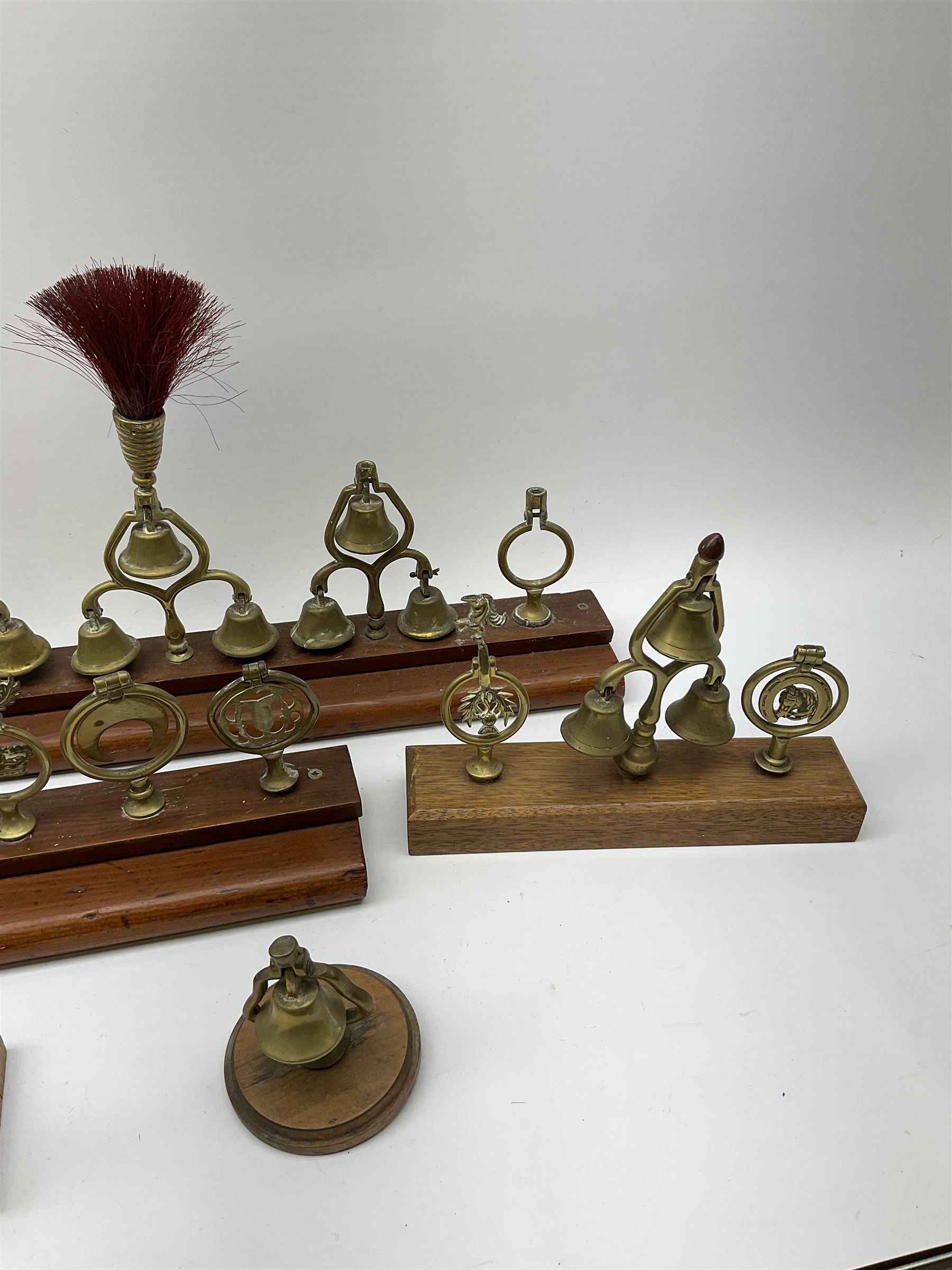 Brass horse terrets, many mounted on wood, including four examples with plumes