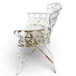 White cast metal garden bench in an antique style