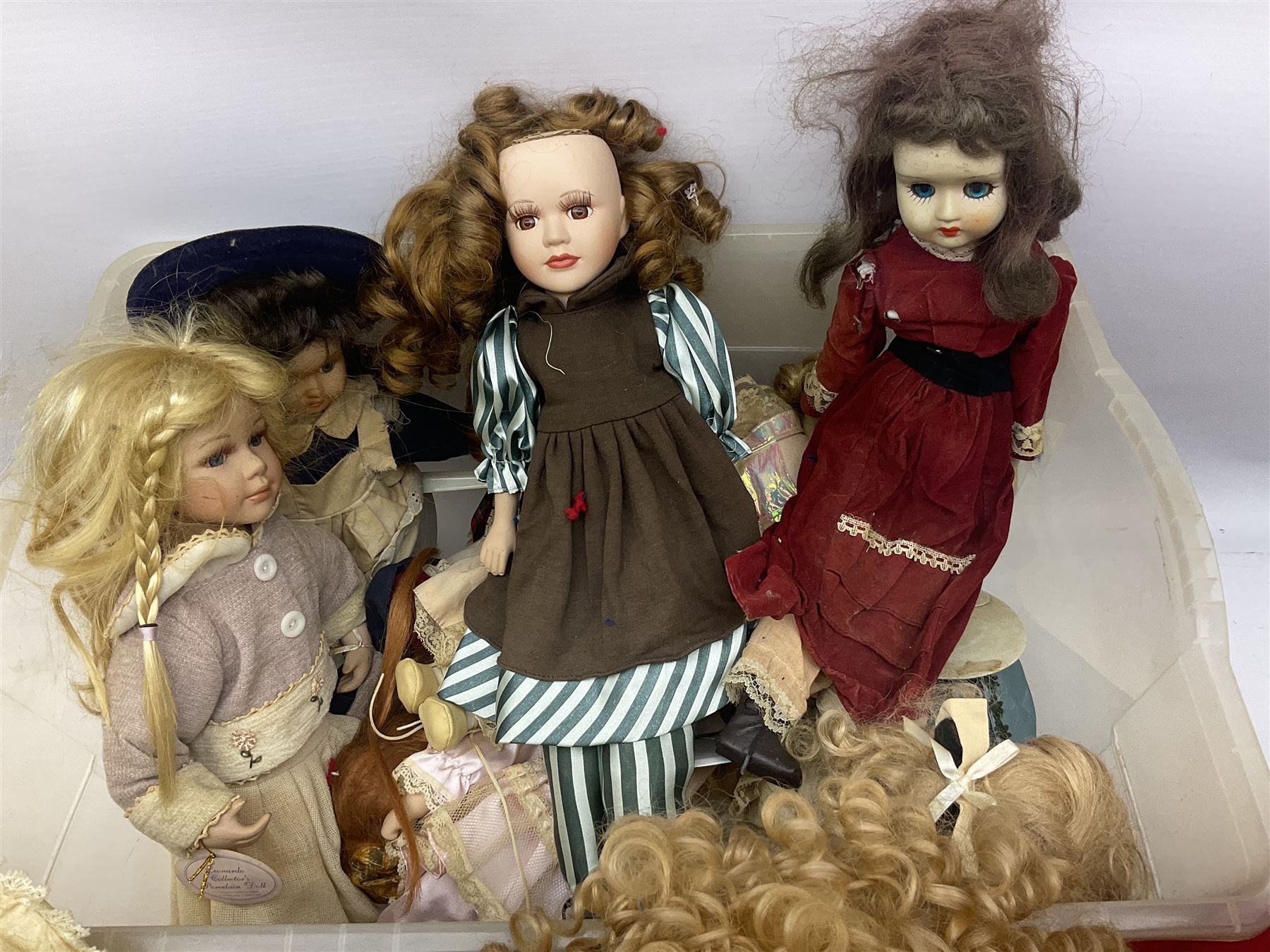 Vintage Paddington bear, with red duffle coat and hat and green Wellington boots, together with a collection of porcelain dolls, paddington H48cm 