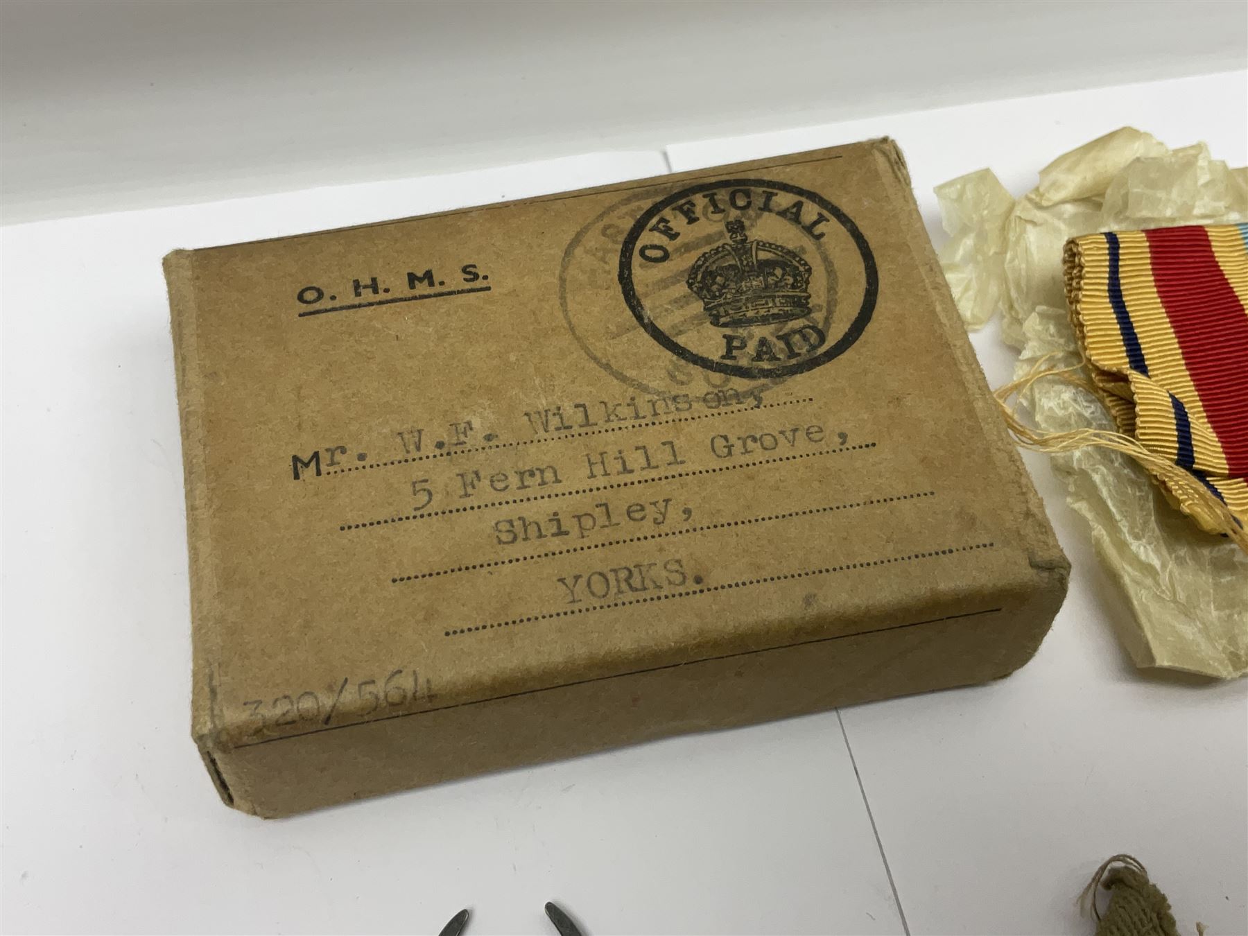 WWII group of three medals comprising 1939-45 War Medal and Italy and Africa Stars in issue box; dog tags for 282894 W. Wilkinson with framed photograph in uniform; and small quantity of cloth and metal badges including RAOC cap badge