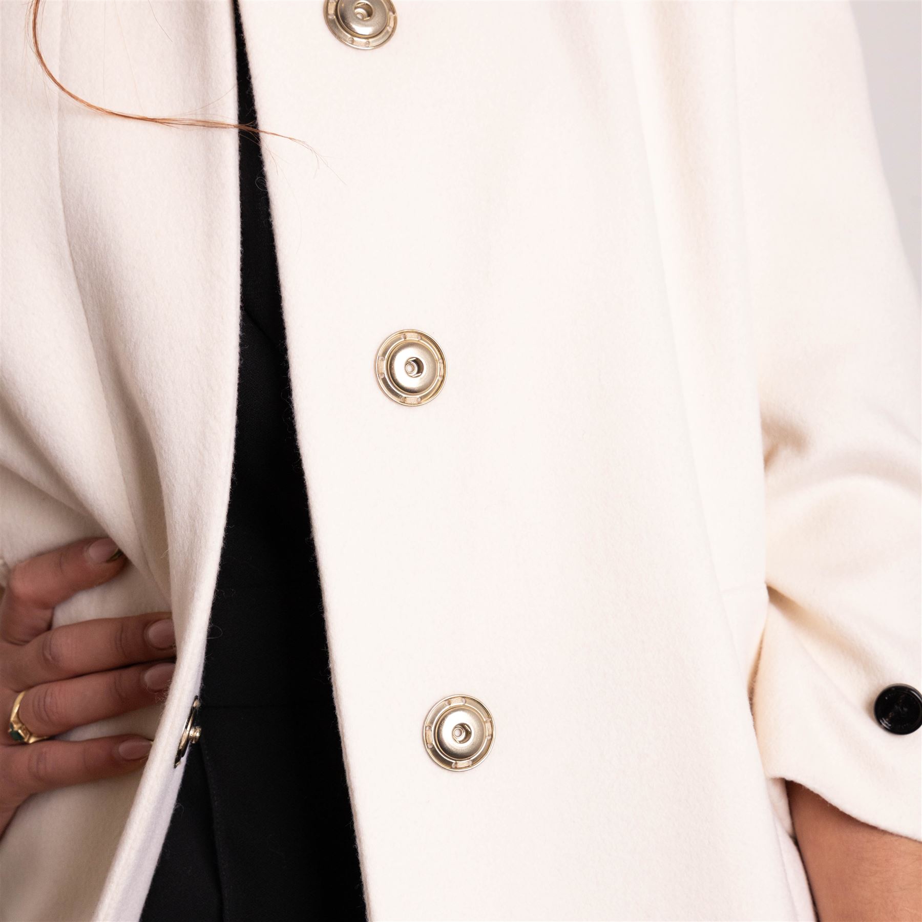 Burberry London - wool coat in cream, with concealed front popper fastening, bracelet-length sleeves with tab and black button detail and side slip pockets, with slit to back, size 40, unused with original Harvey Nichols garment bag and hanger