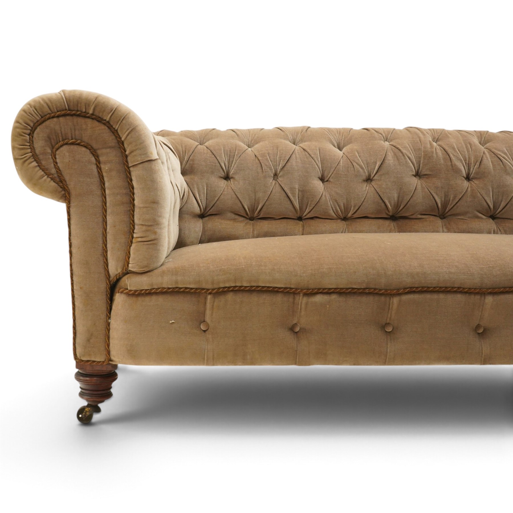 Victorian mahogany framed two seater Chesterfield settee, traditional shape with rolled back and arms over sprung seat, upholstered in buttoned-back neutral fabric, raised on turned front supports with ceramic castors