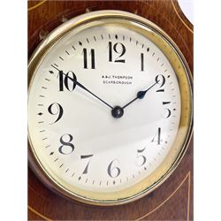 Edwardian inlaid mahogany mantel clock, stepped cavetto and arched top pediment, circular white enamel Roman dial signed 'A & J. Thompson, Scarborough', the front inlaid with fan motif, raised on globular brass feet, single train driven movement by 'R & Co. Paris'