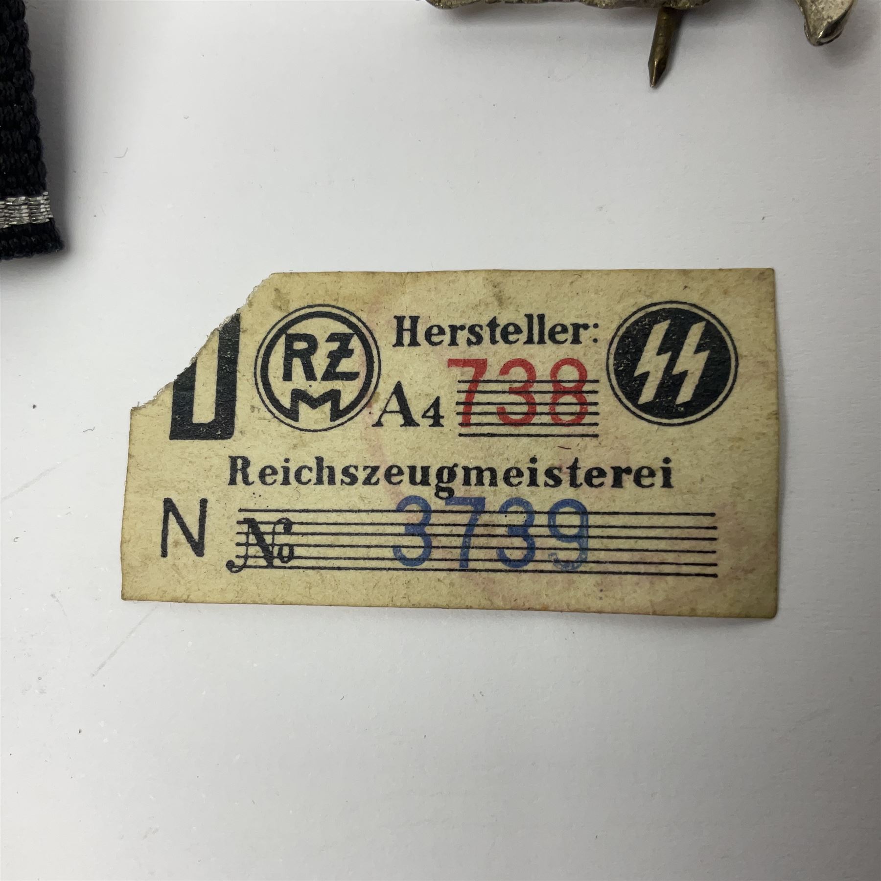 Three Reichsfuhrer 'SS' cuff titles; RZM 'SS' paper tag; German Water Police belt buckle; Destroyers badge marked RKS verso; N.S.B.O. lapel badge; and incomplete party eagle cap badge (8)