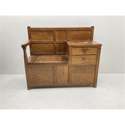 'Acornman' figured oak telephone table, panelled back above hinged seat and two drawers, panelled sides and front, all over adzing, by Alan Grainger of Brandsby, York