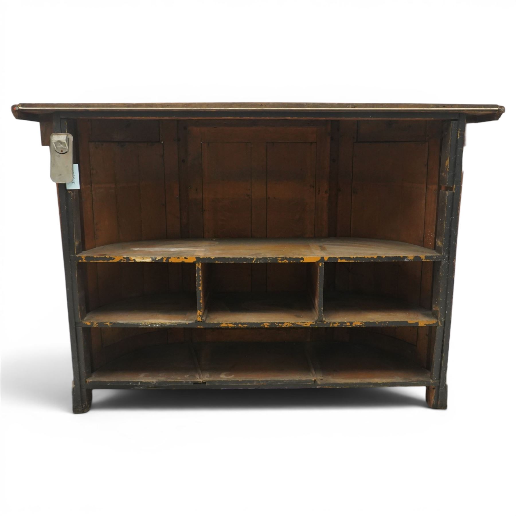 Arts & Crafts oak D-shaped bar, moulded edged counter above a front with velvet applied panels, the back with shelving, raised on a plinth base