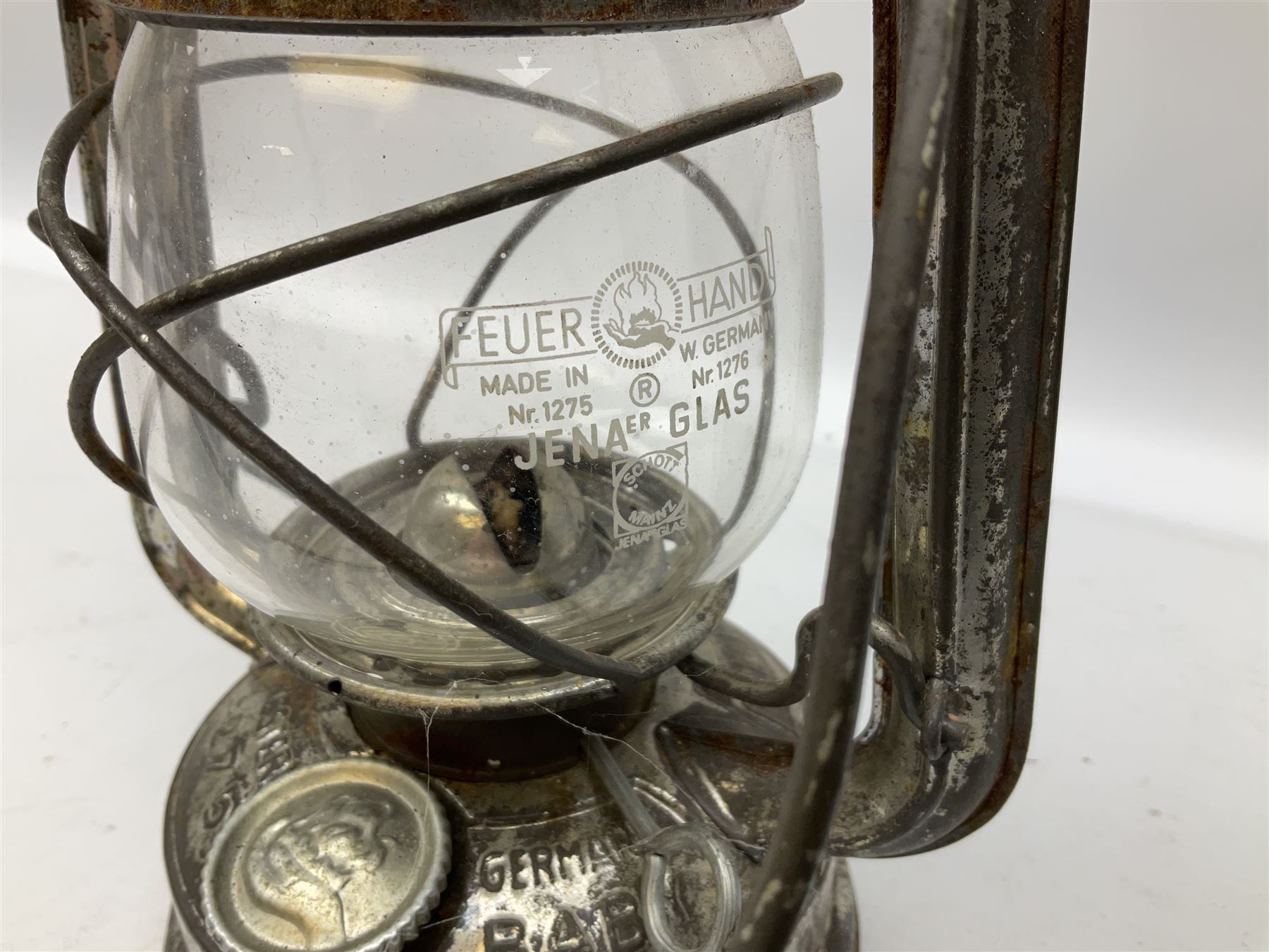 Copper and brass ship’s lamp marked ‘Anchor’, H25cm, Feuer hand storm lantern, Bialaddin Model 315 paraffin lamp and an Anchor lamp (4)