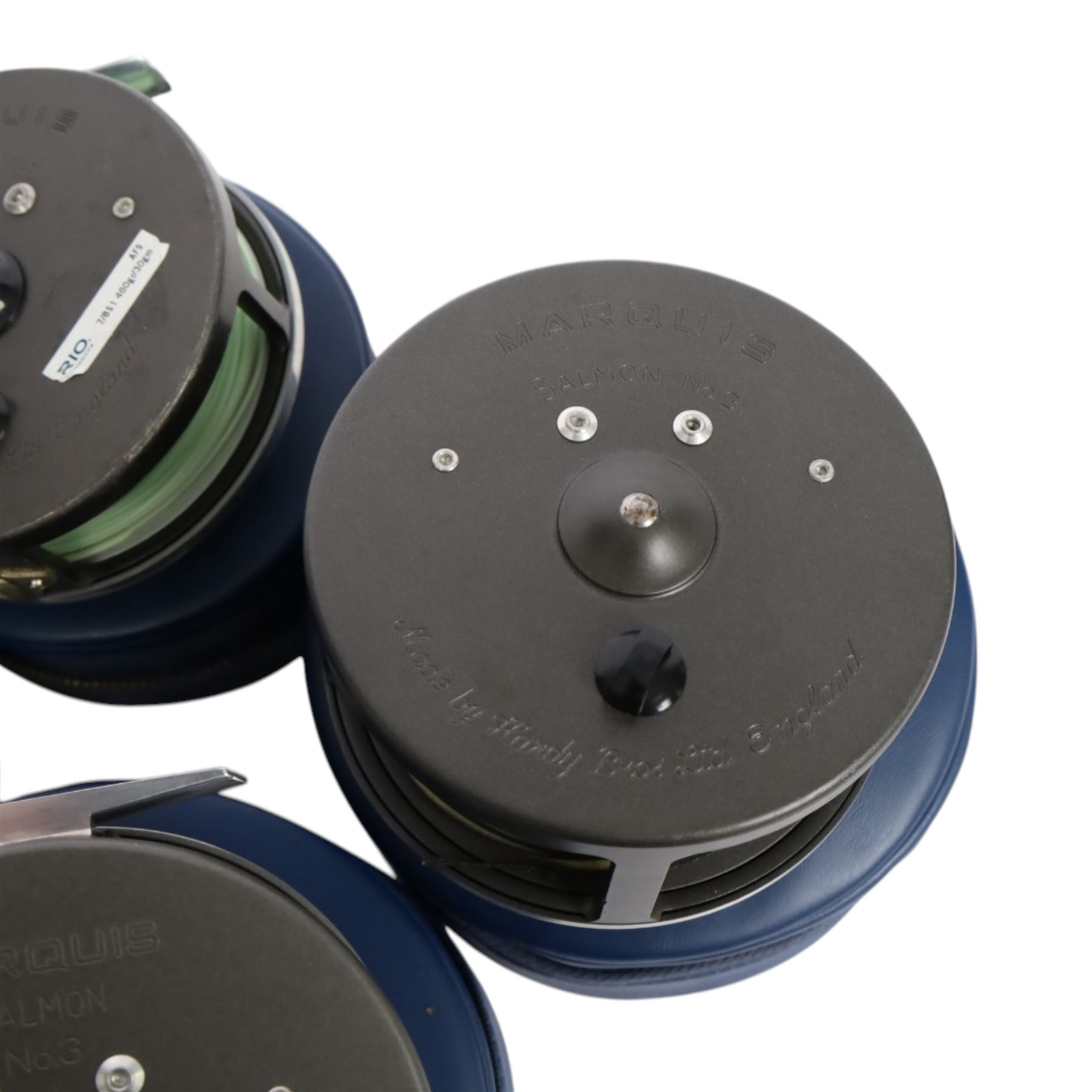 Four Hardy Bros Marquis fly fishing reels, comprising three No. 3 salmon reels and a No.1 Salmon reel, all within blue Hardy cases