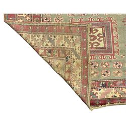 Turkish deep pink and green ground carpet, the square field with hooked borders surrounded by geometric motifs, multi-band border with overall geometric designs 