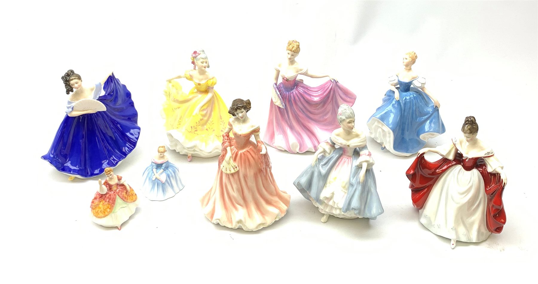  A group of Royal Doulton figurines, comprising Sara HN2265, Southern Belle HN2425, Summer Serenade HN3610, Ruth HN4099, Elaine HN2791, Figure of the year 2000 Rachel HN3976, and Ninette HN2379 (a/f), plus two smaller Royal Doulton figurines, Victoria HN3909, and Christine HN3269 (a/f).  