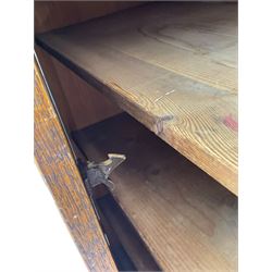 The North of England School Furnishing Company Limited Darlington - early 20th century oak school cupboard, projecting moulded cornice over two panelled doors, fitted with shelves, on chamfered plinth base 