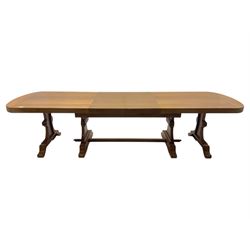 Oak extending dining table with elegant scrolled shaped double pedestal base and scrolled feet; together with a set of eight ladder back chairs with rush seats ((9) table closed 228x95x79cm chairs 106x38x44cm 