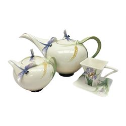 Franz Teapot decorated with dragonflies, together with a matching sucrier and cover and a cup and saucer in Iris pattern, all with printed mark beneath 