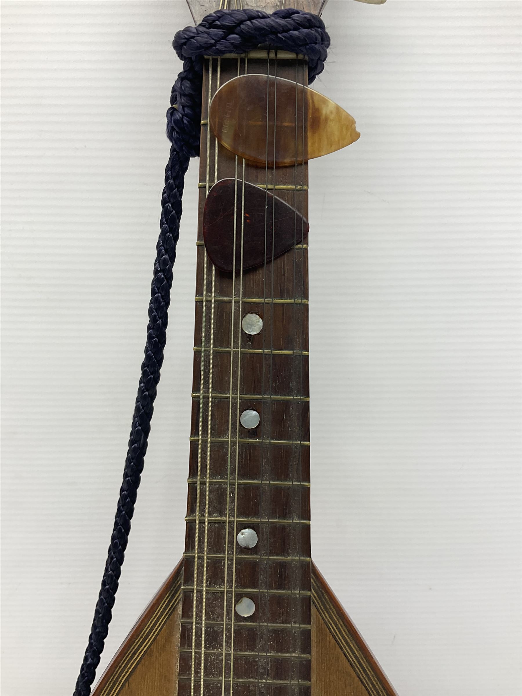 Late 19th/early 20th century Italian lute back mandolin with segmented back and spruce top; bears maker's label for Pietro Tonelli Napoli; together with a mandolin instruction booklet and a folding music stand L60.5cm