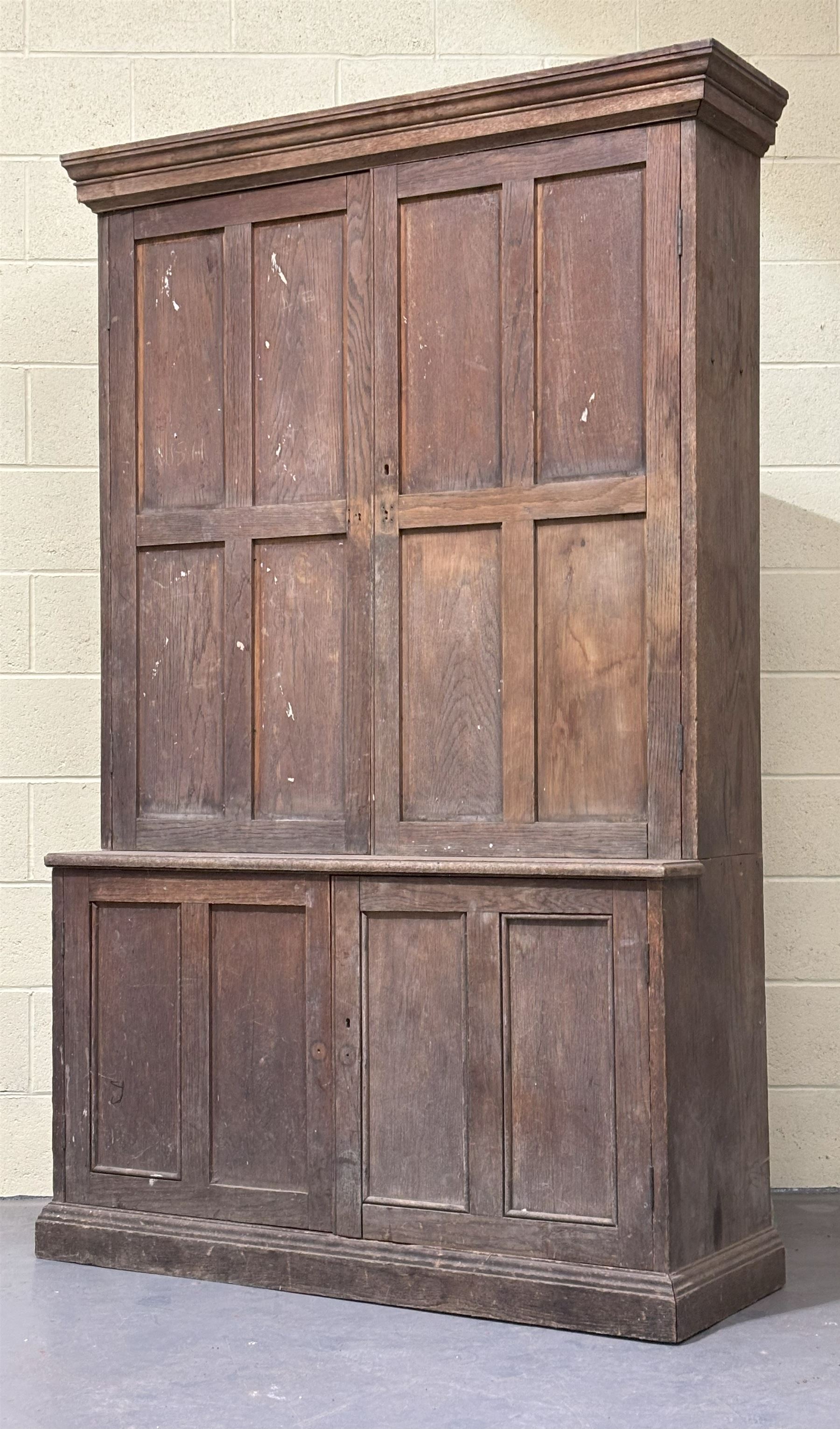 Late Victorian oak cupboard, the moulded cornice above two panelled doors, each enclosing three shelves, the base with two further doors opening to shelves behind. H214cm, W130cm, D48cm. - COLLECTION BY APPOINTMENT FROM: The White House, Thirsk Road, Easingwold, York, YO61 3NF - CALL 01723 507111 TO ARRANGE