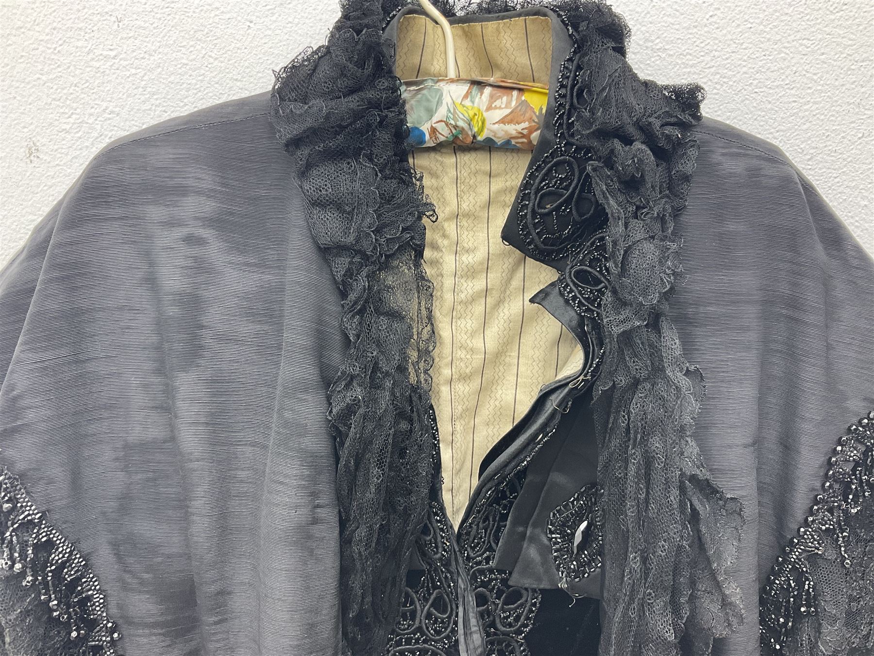 Victorian three piece mourning dress, with lace trim and jet beading, including velvet coat with satin collar panels and cuffs, the nipped waist with boning and slight flared peplum, heavily embellished beaded high neck collar, and ladies embroidered silk lined purse with gilt handle, mount and clasp