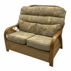 Light wood and cane two seat conservatory sofa, loose beige patterned cushions
