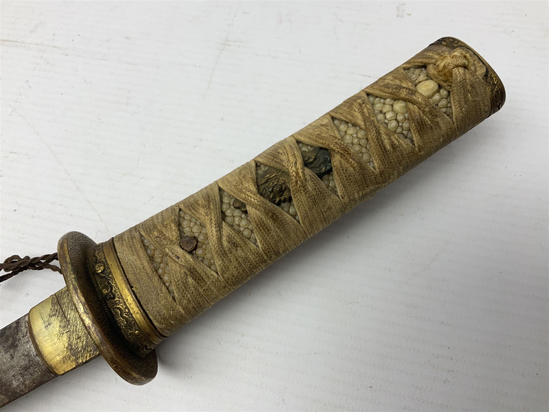 Japanese tanto dagger with 25cm single edged blade, gilded plain punched tsuba, cord bound ray skin grip incorporating menuki and ornate gilded metal mounts L39cm overall