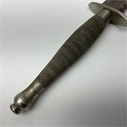 First Pattern Fairburn Sykes ''F-S'' Fighting Knife by Wilkinson Sword Ltd., the 17cm double edge steel blade with raised medial ridge to each side, each side of the ricasso with a recessed panel, one side with maker's name, the opposing side etched THE F~S FIGHTING KNIFE, with nickel plated brass recurving crossguard and diamond cut grip; in leather scabbard with metal chape