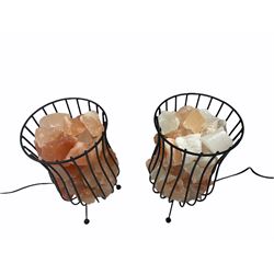 Two salt crystal lamps, supported in wire stands
