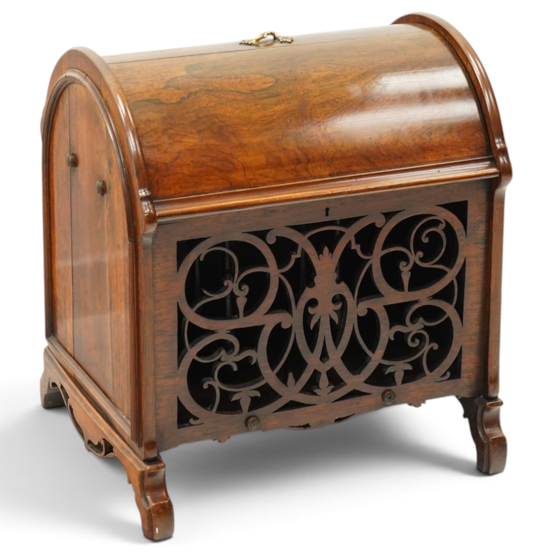 Victorian rosewood enclosed music Canterbury, the domed hinged cover enclosing a three-division interior, above a pierced scrolling foliate fretwork front panel, flanked by curved uprights and raised on scroll feet, hinged top applied with brass registration lozenge for 19 January 1860