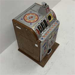 A one arm bandit fruit slot machine, the oak case with cast metal front and top with polychrome detail, with jackpot windows and single pull arm, patent no to front, H62cm. 