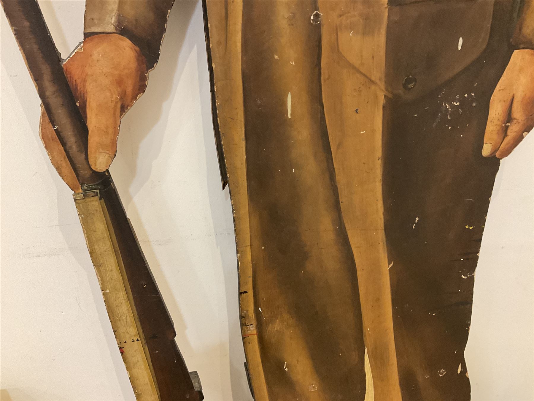 Military Outfitters hand painted life size wooden cut out figure of a WW1 soldier standing at ease holding a gun by his side, marked Stening Signs; hardboard on planked frame H199cm