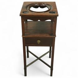 George III mahogany washstand, square top with circular wash bowl aperture and twin bottle recesses above a shaped frieze and single drawer with brass knob handle, raised on square tapered legs united by cross stretchers 
