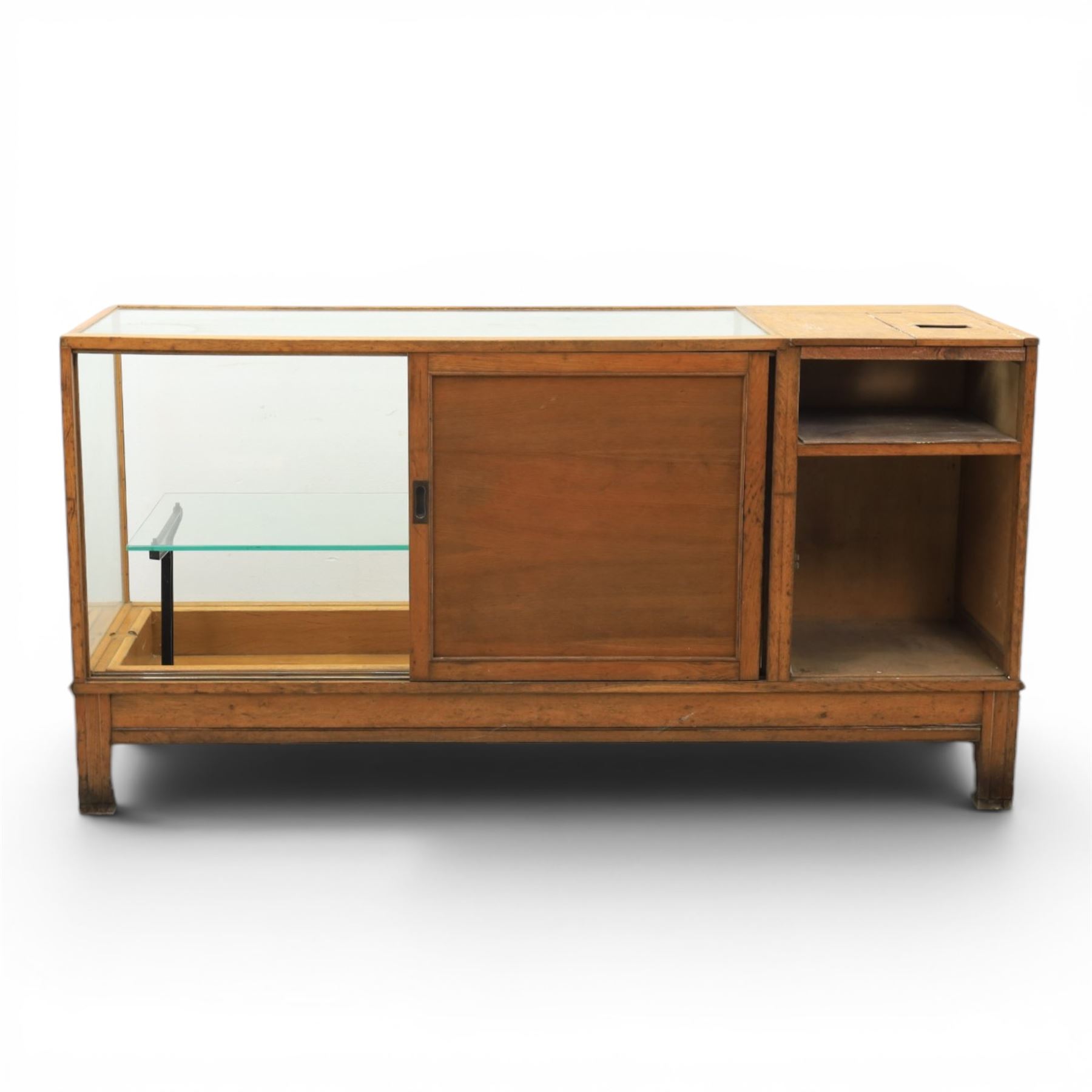 Early 20th century oak framed and glazed haberdashery shop counter with sliding doors and cupboards