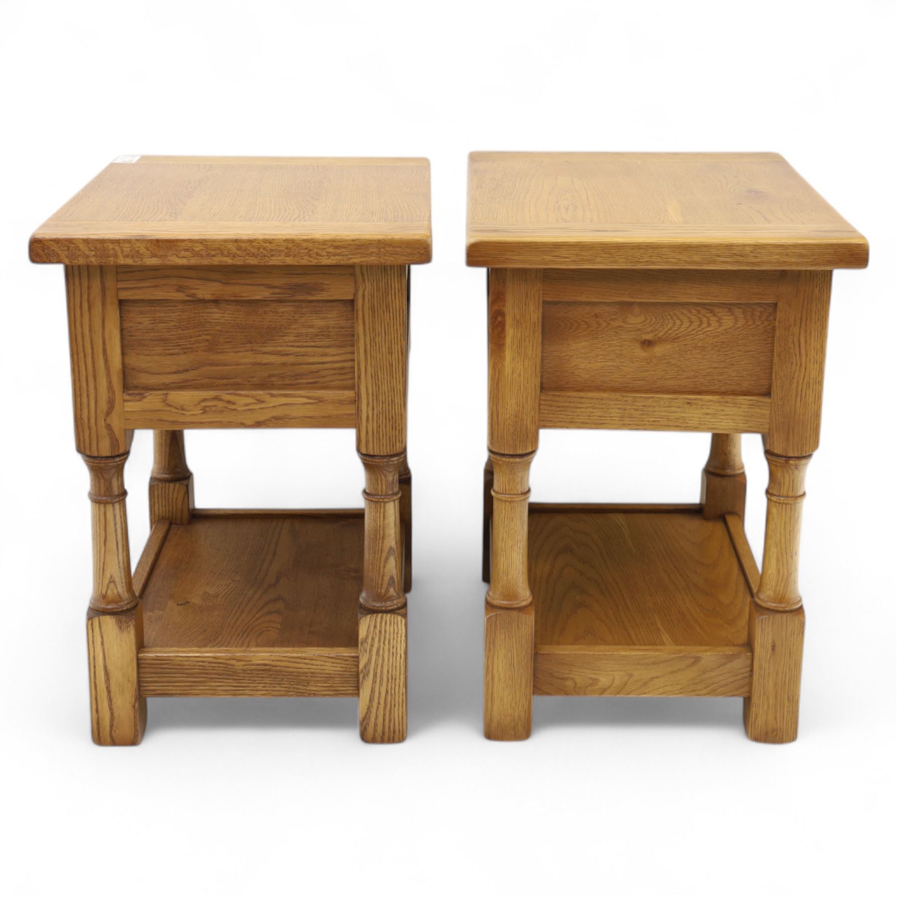 Old Charm - ‘Chatsworth’ pair of light oak lamp tables, each with moulded rectangular top, single drawer and metal drop handle, raised on turned supports joined by undertier shelves