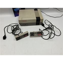 Nintendo Entertainment System (1985) console with two controllers, accessories and instruction booklet. NES Games ‘Duck Hunt’ with Nintendo Zapper gun, ‘Pinball’ and ‘Super Mario Bros.’, all with original sleeves and instruction booklets. NES game ‘Super Mario Bros. 2’ cartridge only