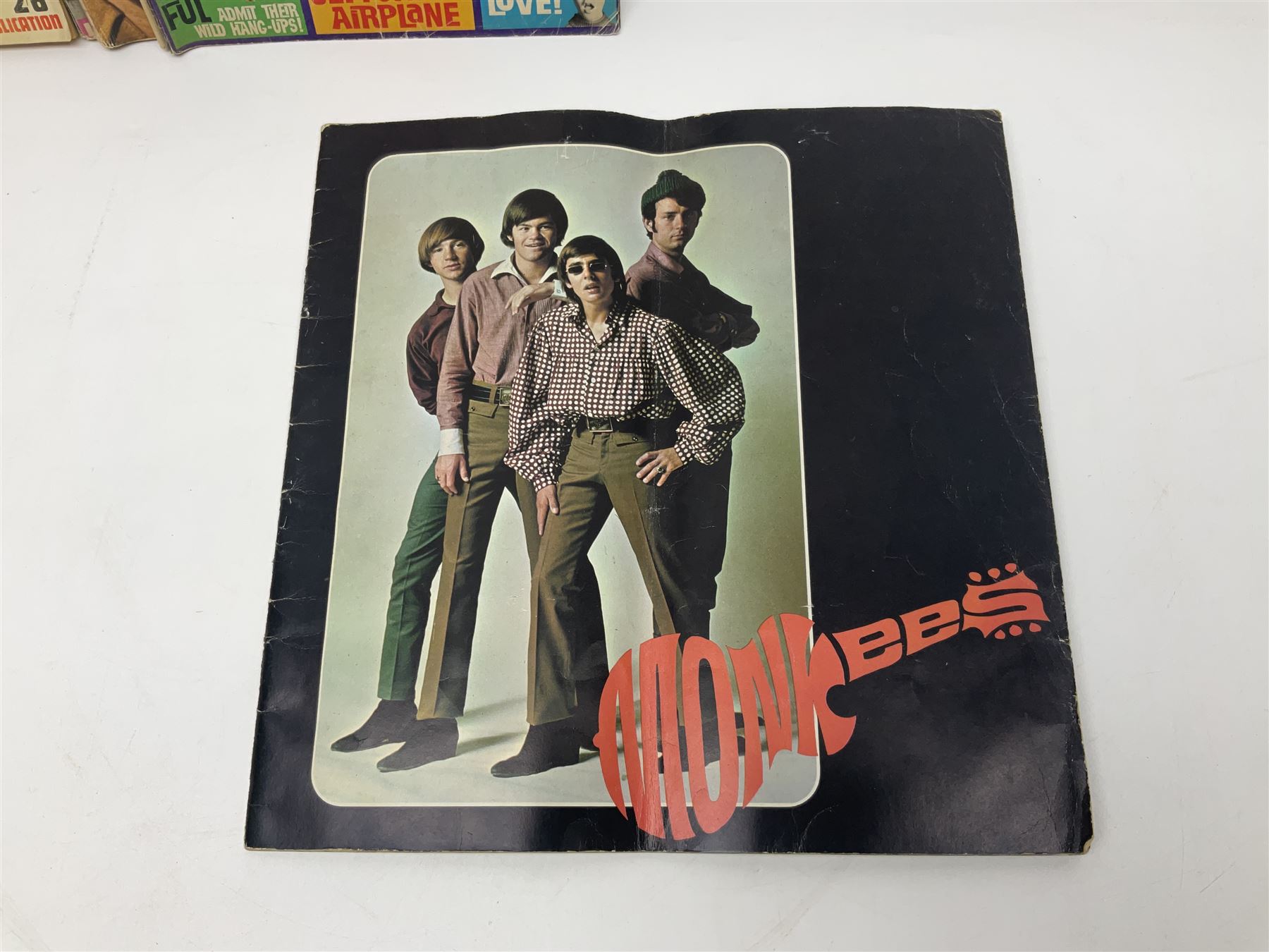 Monkees memorabilia - 'Monkees Monthly' magazine almost complete run from No.1 Feb 67 to No.31 Aug 69 (lacking nos.29 and 32); the cover of No.1 signed by all four members of the group during their 1997 Reunion Tour; quantity of A&BC bubble gum cards; programme for their only UK live performance in 1967 at Empire Pool Wembley; and other related late 1960s music magazines/paperback book