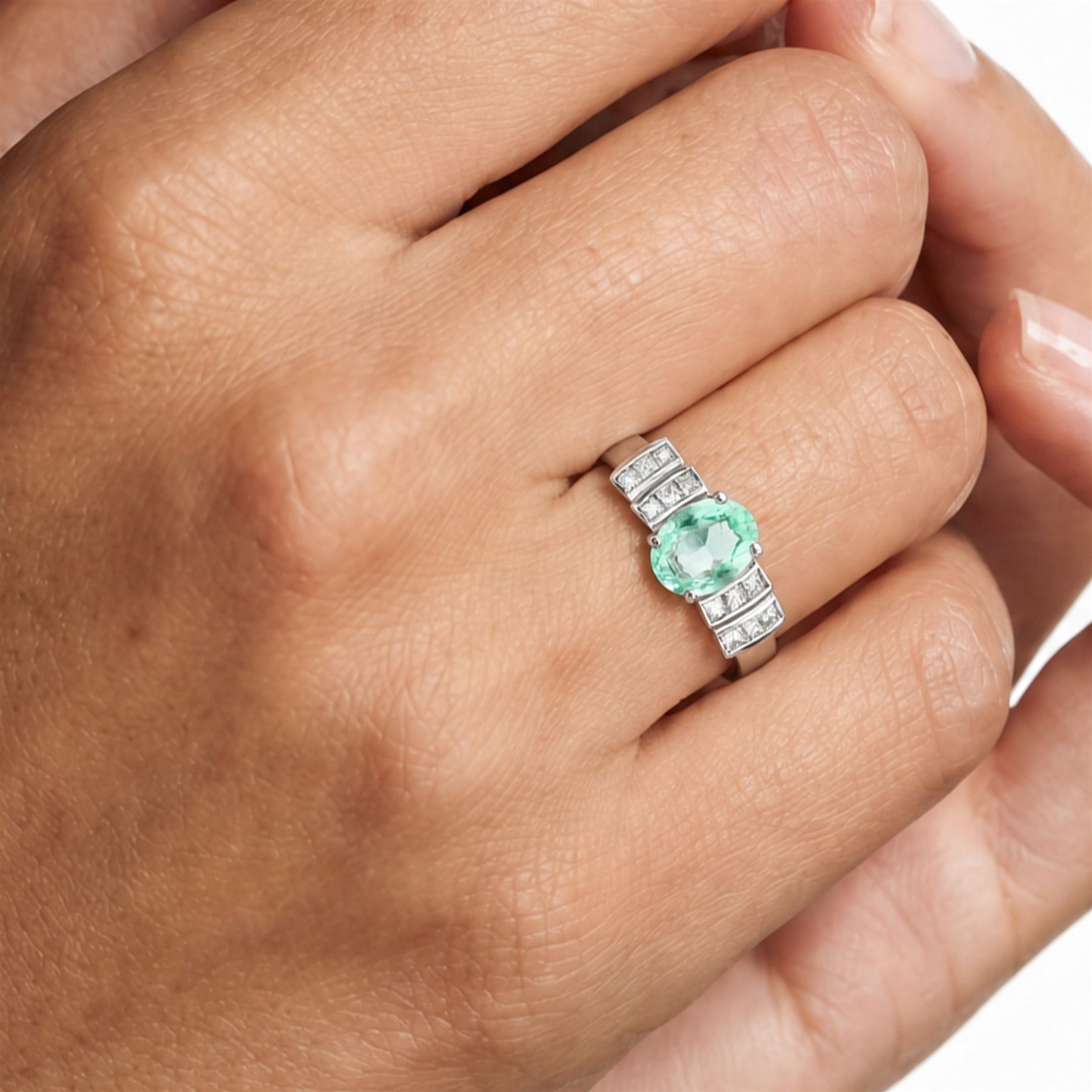 18ct white gold Paraiba tourmaline and diamond ring, single oval cut tourmaline of approx 0.90 carat, with six princess cut diamonds either side, in a stepped design setting, hallmarked, total diamond weight approx 0.35 carat