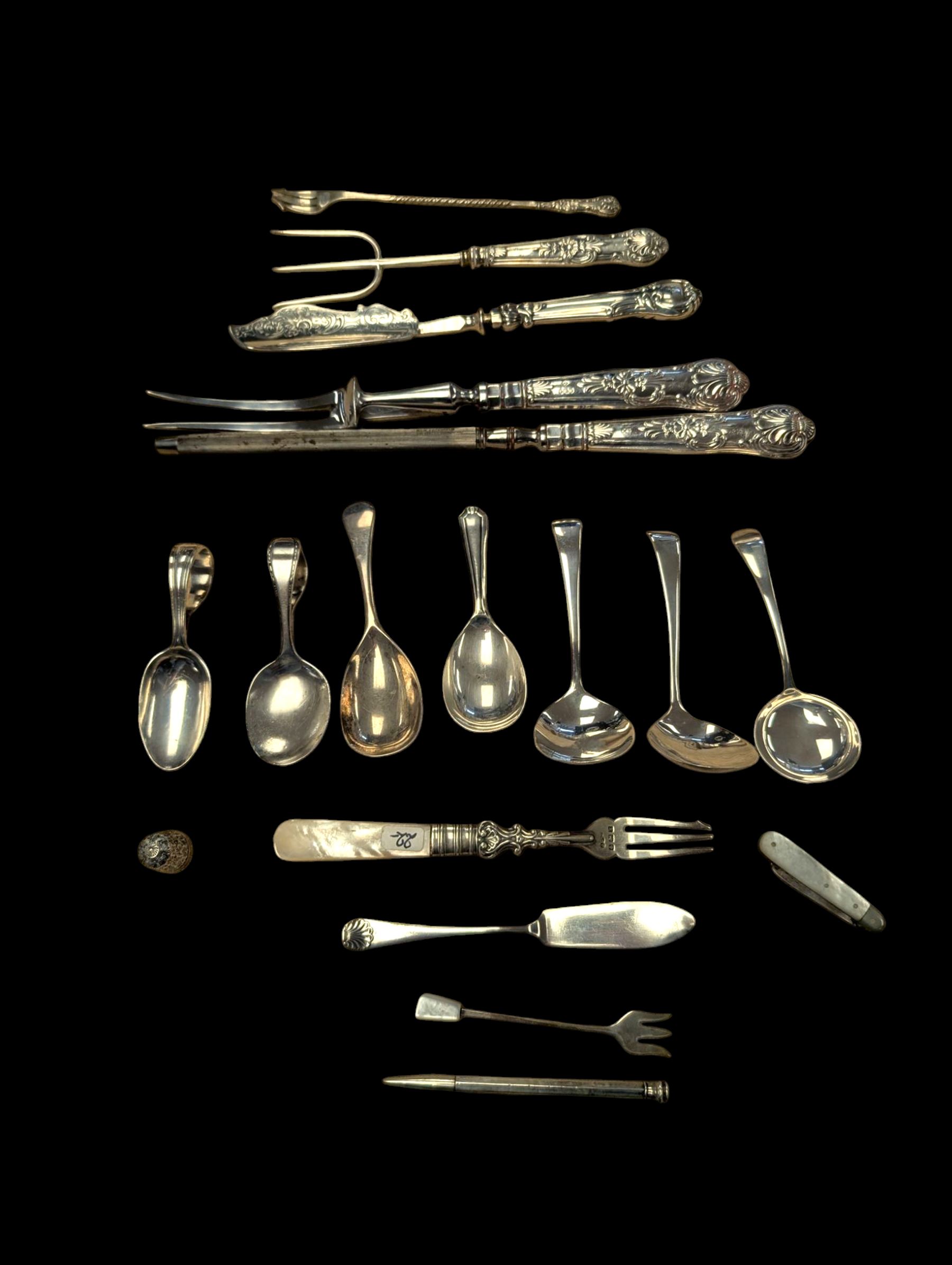 Group of silver and silver handled cutlery, including caddy spoons, thimble, propelling pencil, fruit knife, etc, all stamped or hallmarked