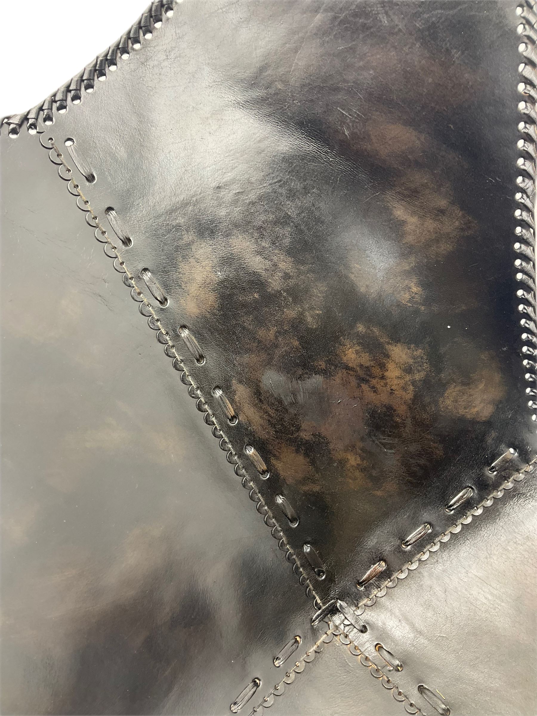 Metal framed butterfly chair upholstered in slung dark tan stitched leather 