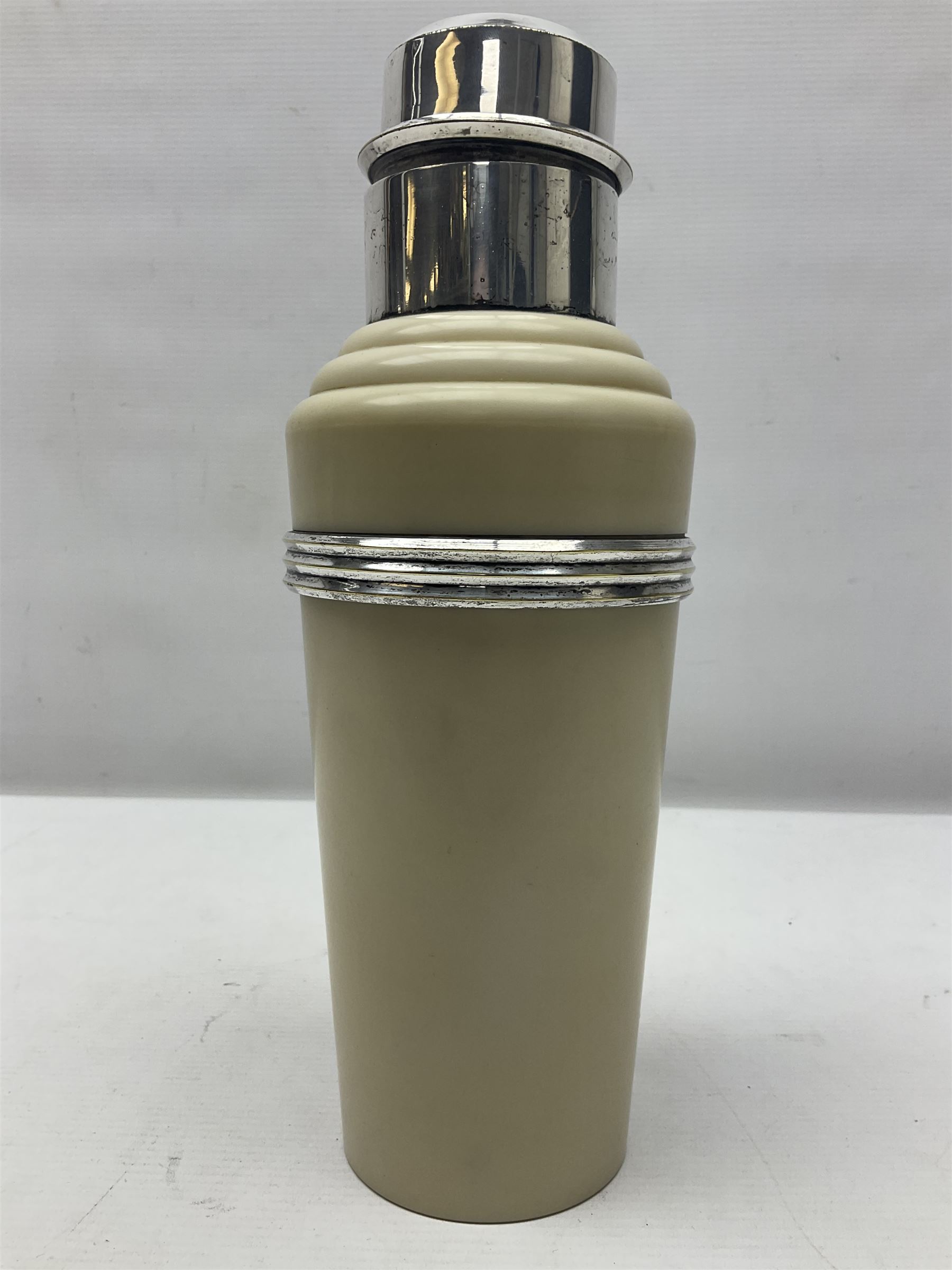 Art Deco 'The Master Incolor' cocktail shaker, in cream Bakelite and silver-plated, with a swivel panel in the cover revealing cocktail recipes, with makers mark beneath, H28cm